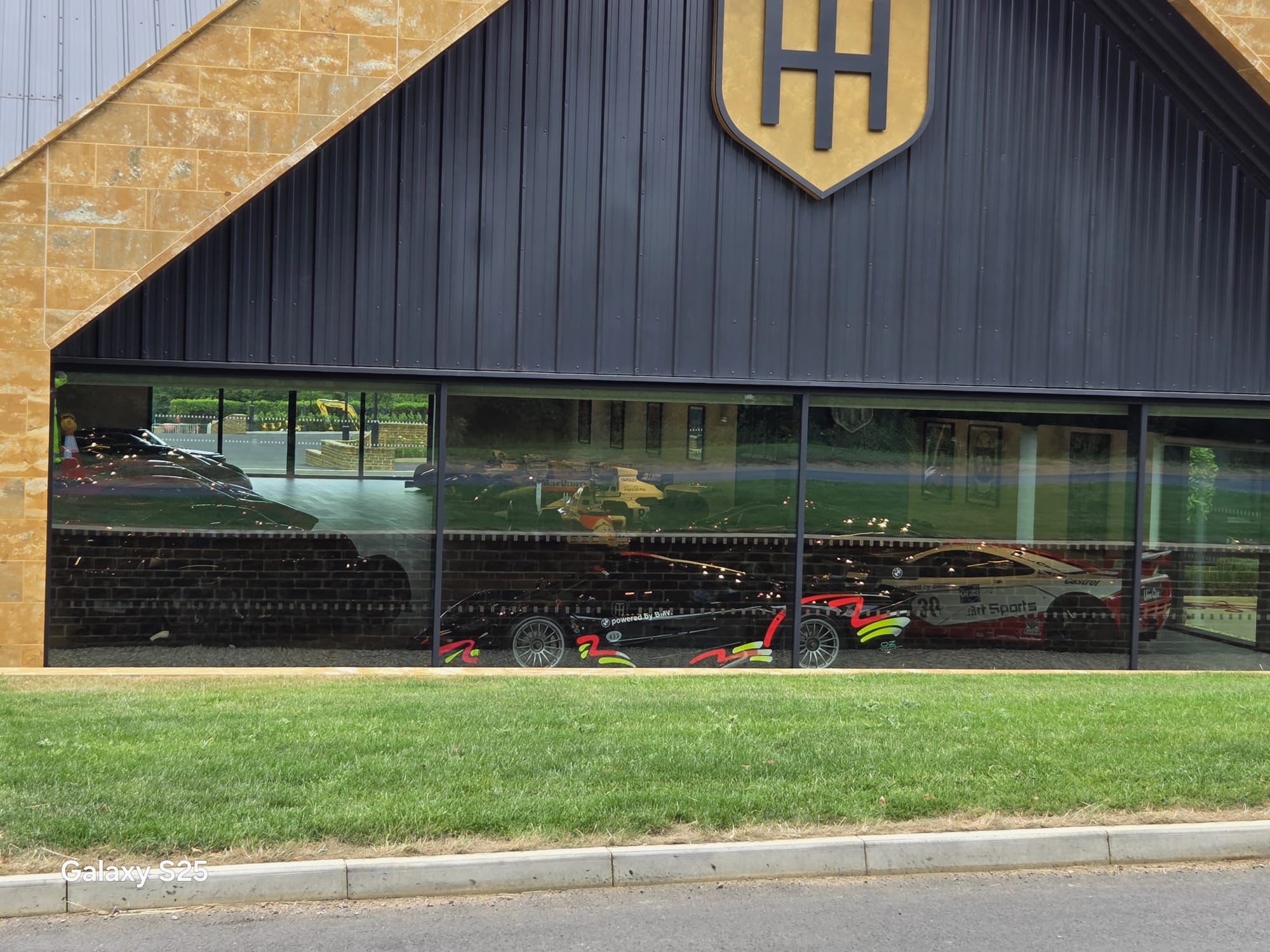 Completed venue building housing a car collection, seen from the finished access road