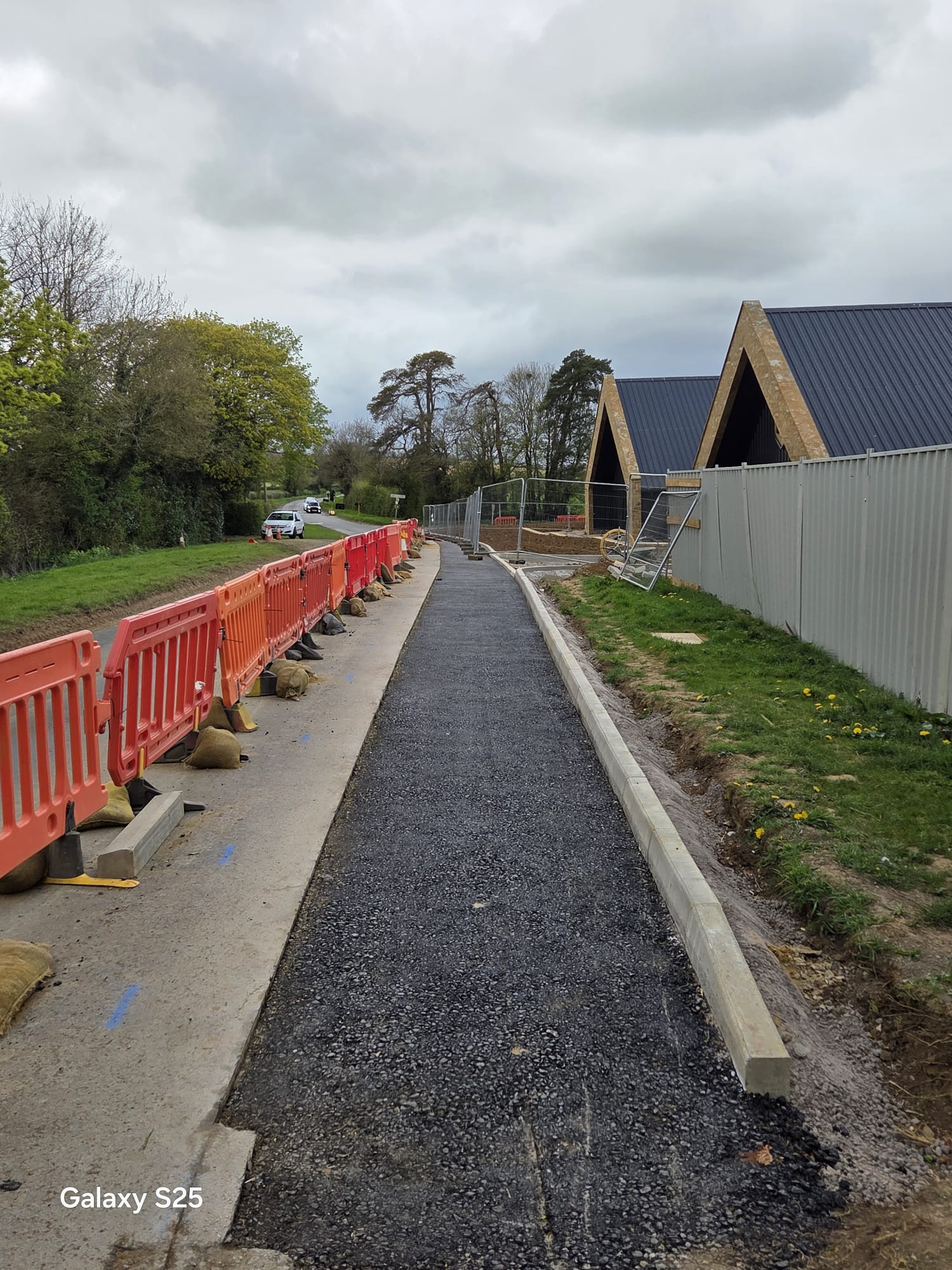 New footway under construction with pedestrian management barriers in place