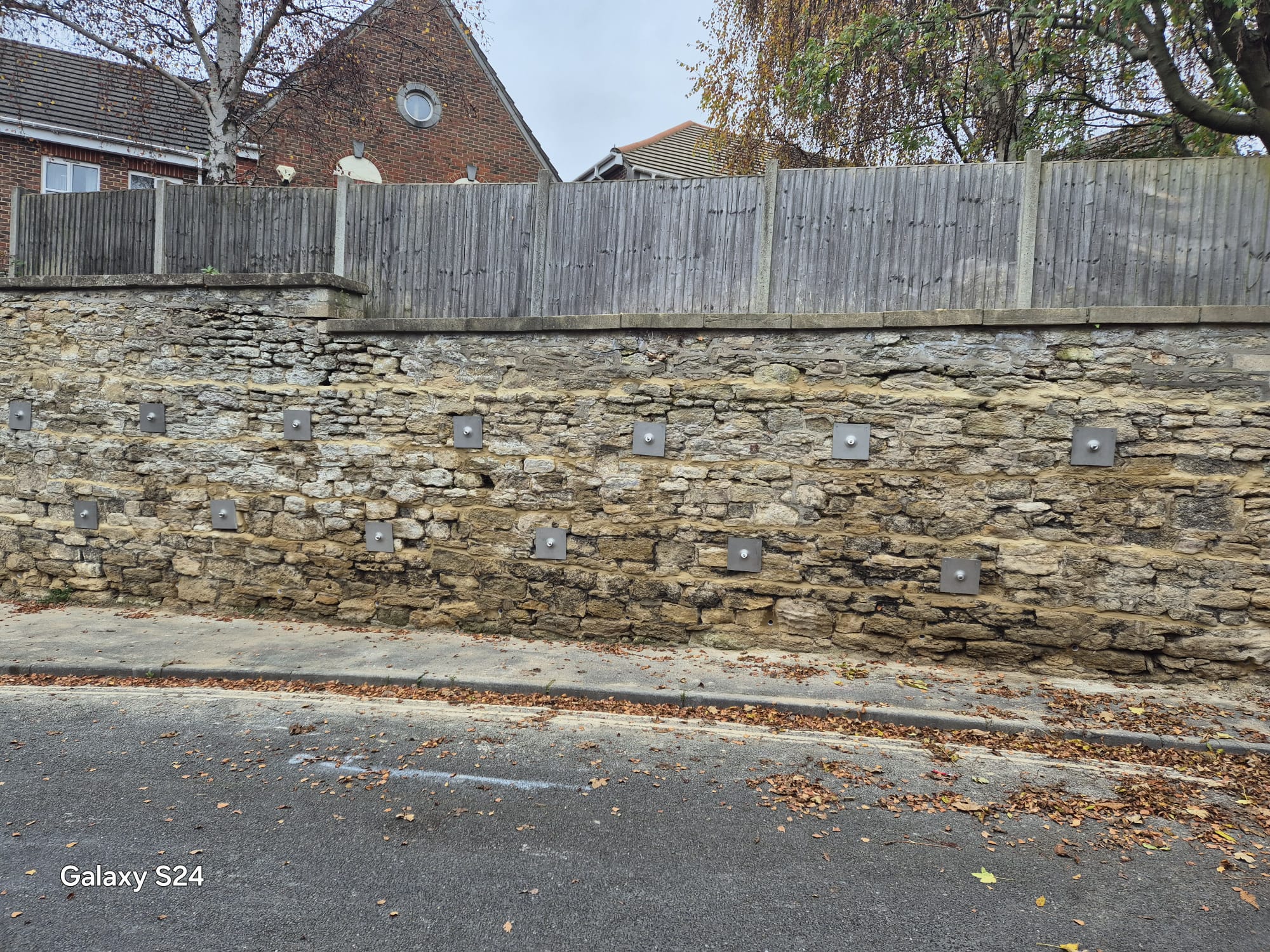 Repaired roadside stone retaining wall following completion of works