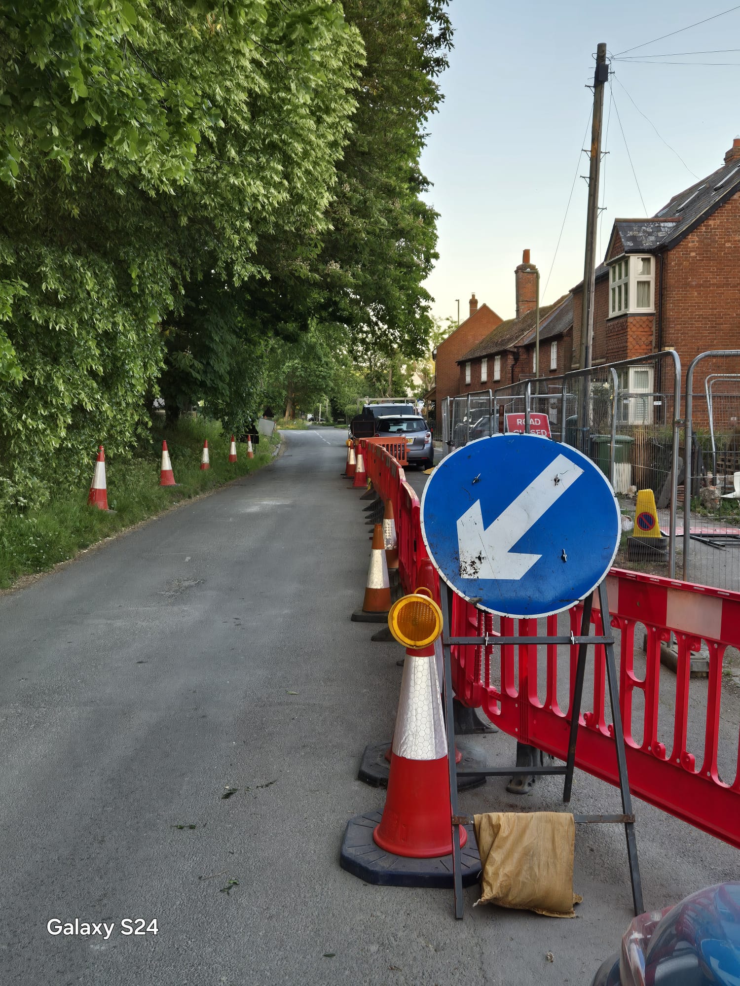 Barriers and cones separating footway works from a residential street