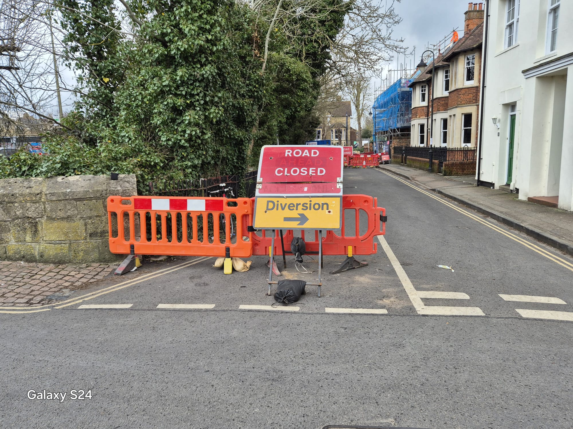 Diversion arrow and road ahead closed sign positioned at a junction