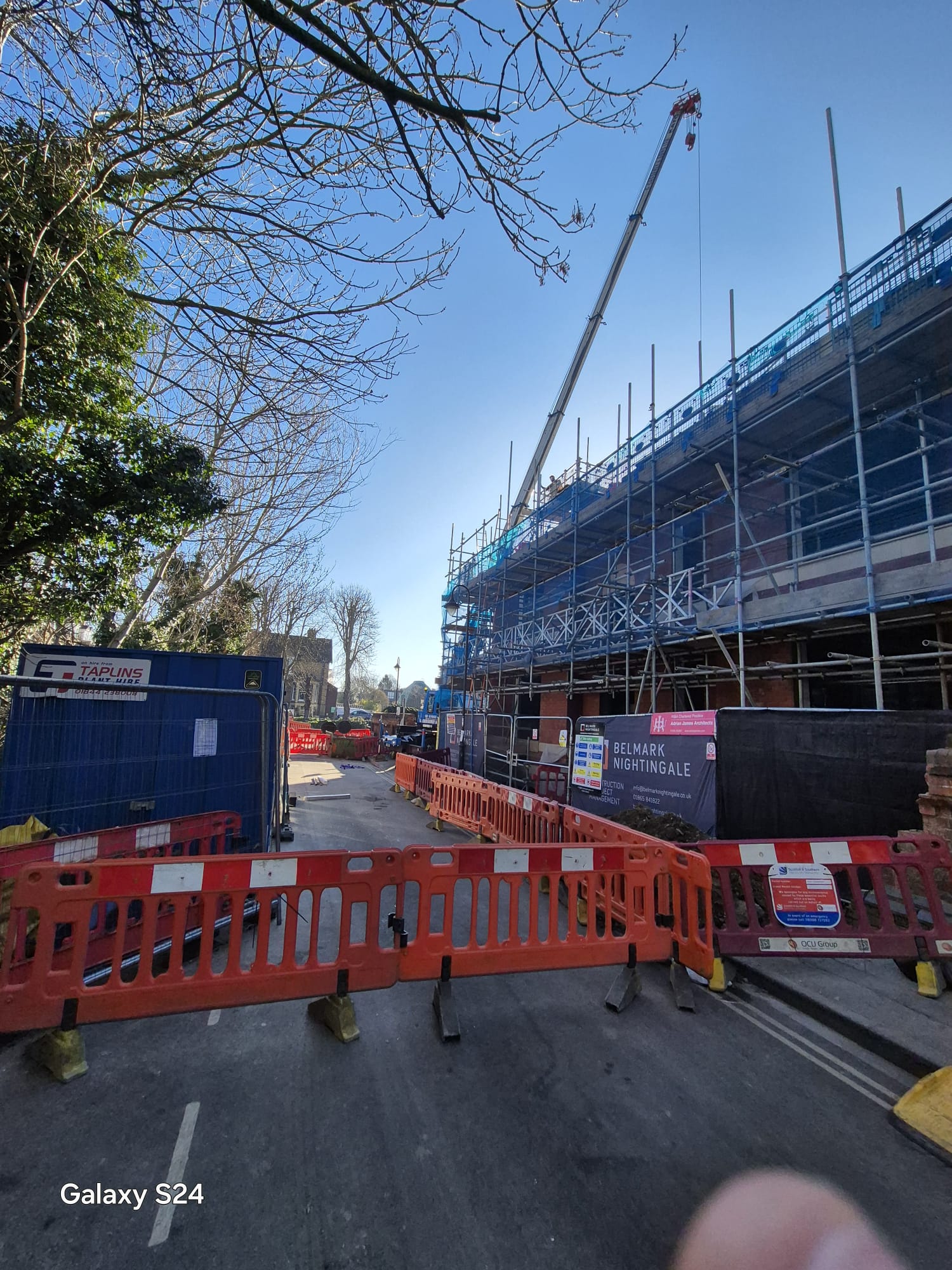 Road closure barriers protecting a crane and construction compound